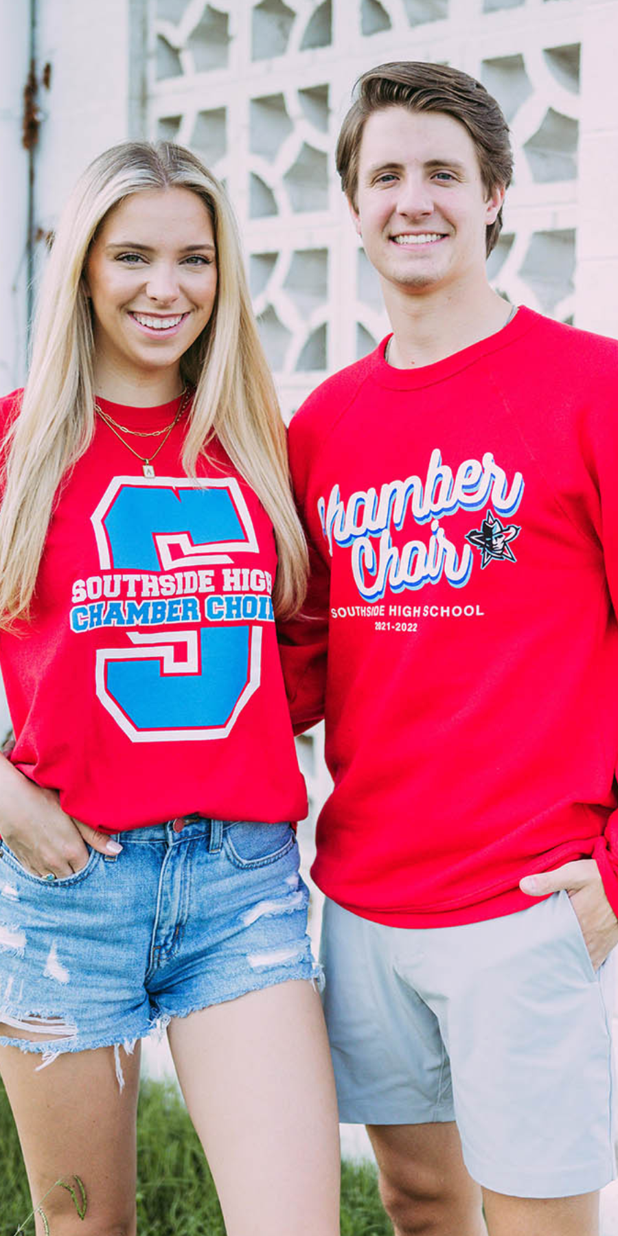 Boy and girl stand together wearing red Southside High School Chamber Choir shirts.